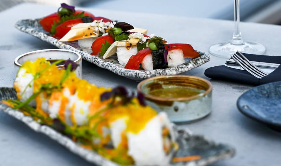 Two plates of artfully prepared sushi and fresh ingredients in the #herrhoshi restaurant in Ahrenshoop.