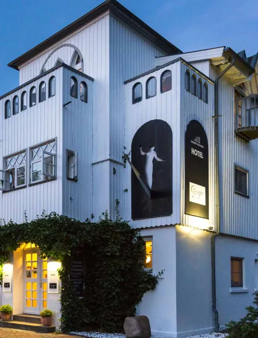 Illuminated Hotel Elisabeth von Eicken at dusk, historical architecture and stylish design.