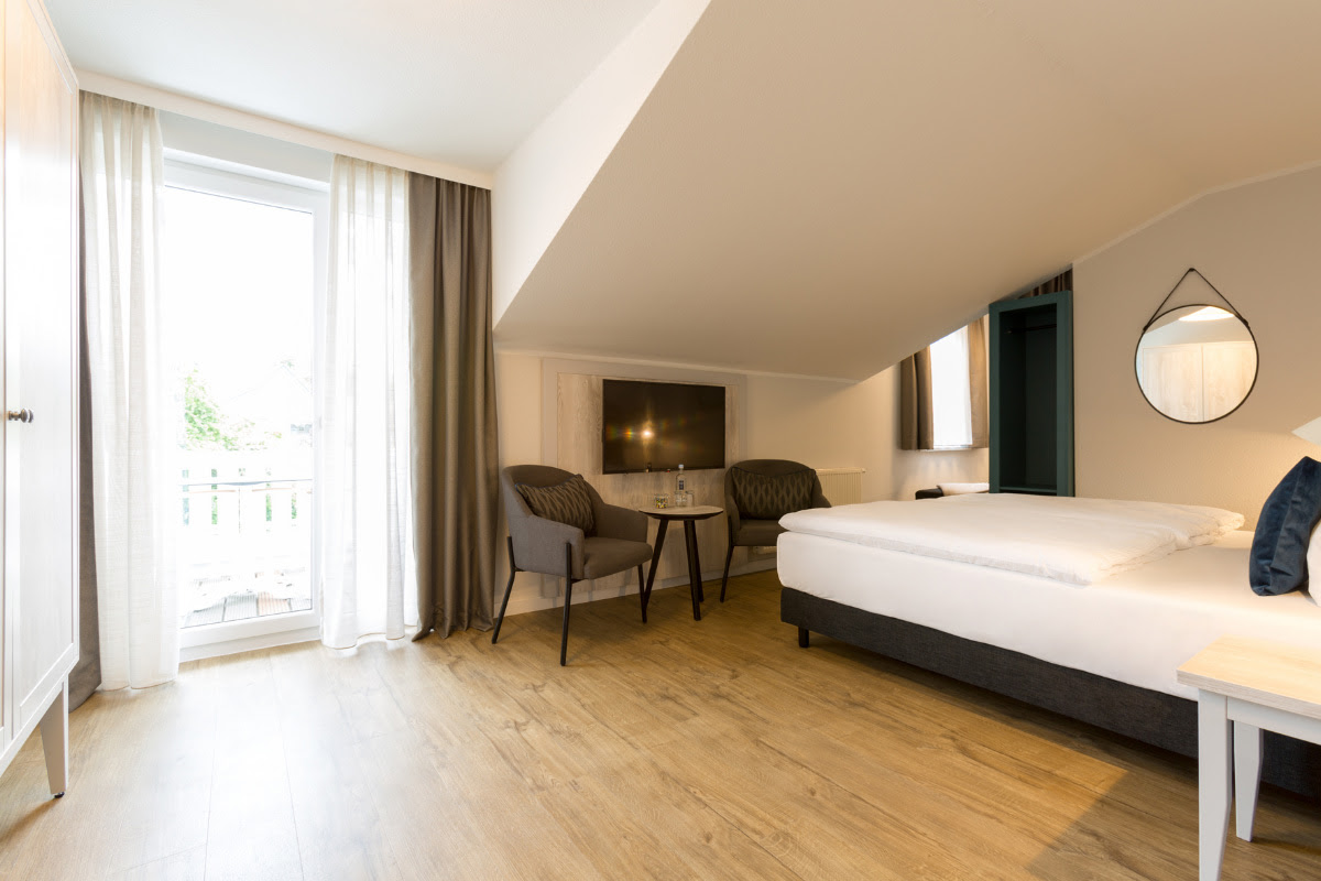 Insight into the superior double room with balcony in modern style at Koopmanns Hotel &amp; Lädchen.