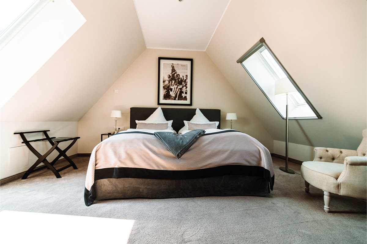 Bright bedroom in the Strandblick vacation apartment in the Hotel Künstlerquartier Seezeichen with double bed and plenty of natural light.