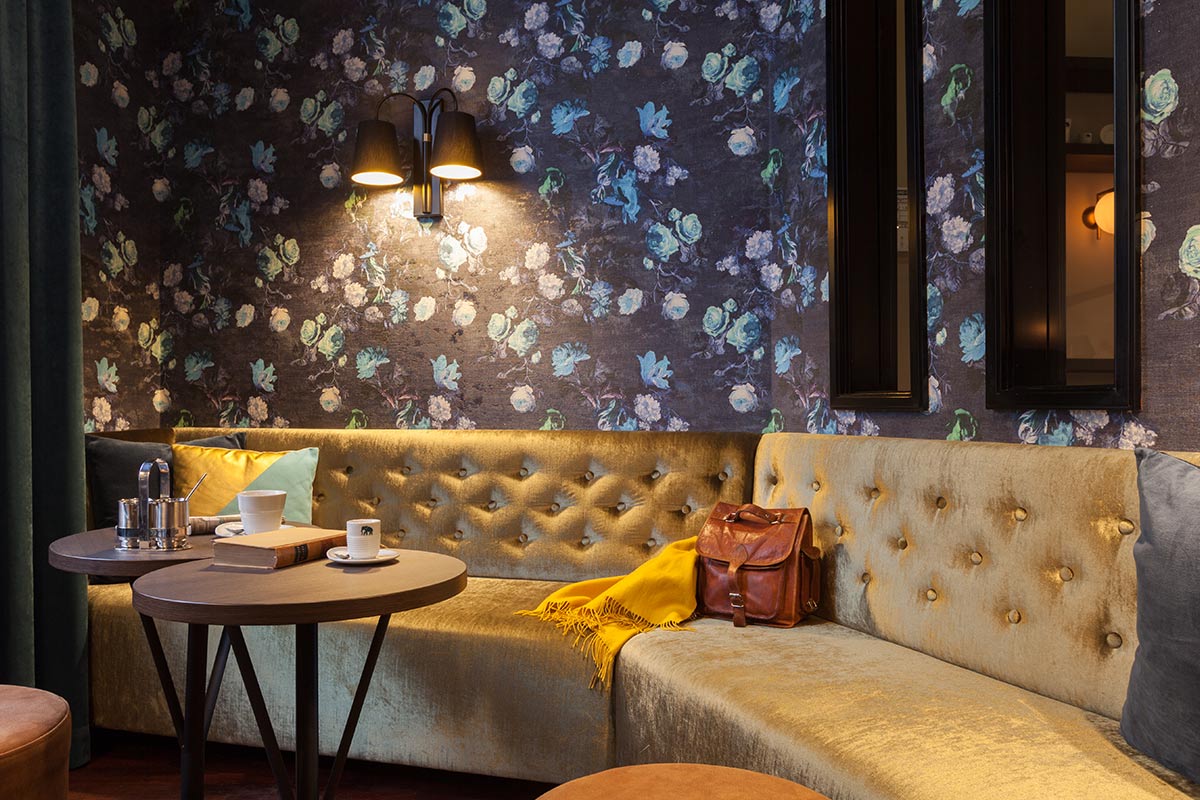 Cozy seating area with coffee table, soft cushions and stylish wall decoration in an elegant room.